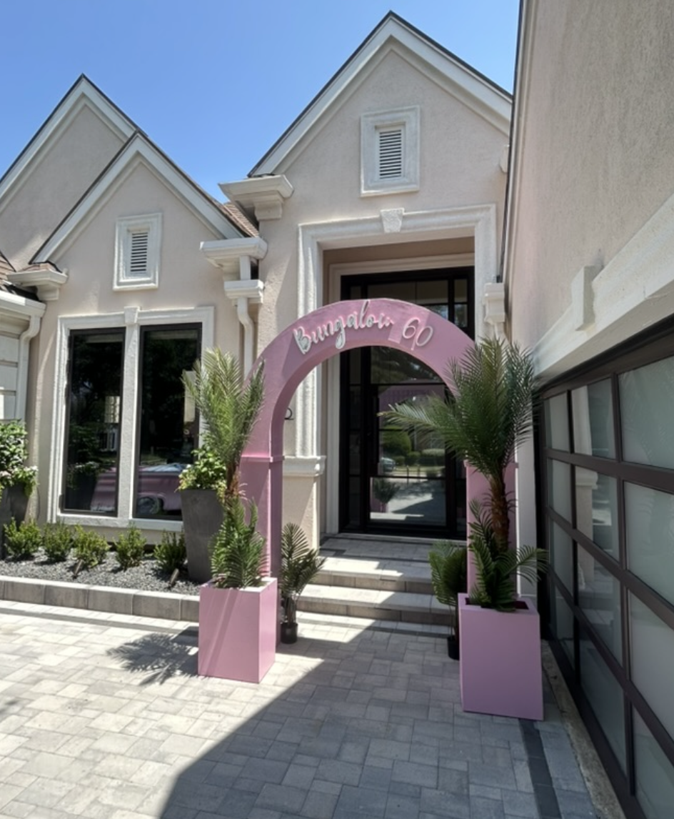 Custom pink Bungalow 60 entrance arch with matching planter boxes